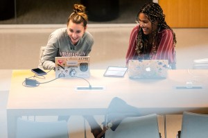 Two students meet on campus at Northeastern.