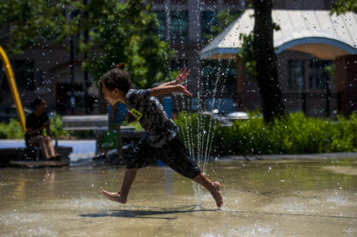 Brody Lomax, 5, of Boston cools off while playing in the splash pad at Carter Playground during the heat wave. Photo by Alyssa Stone/Northeastern University