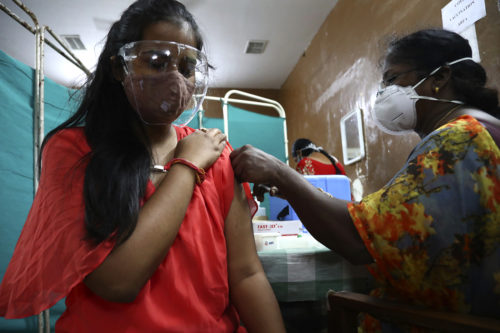 Indian woman receiving a vaccination shot