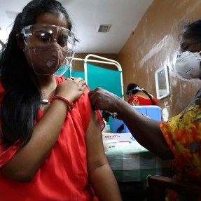 Indian woman receiving a vaccination shot