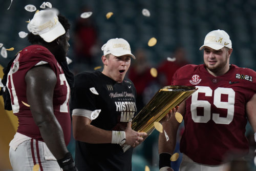Alabama football players celebrate their national championship in 2021.