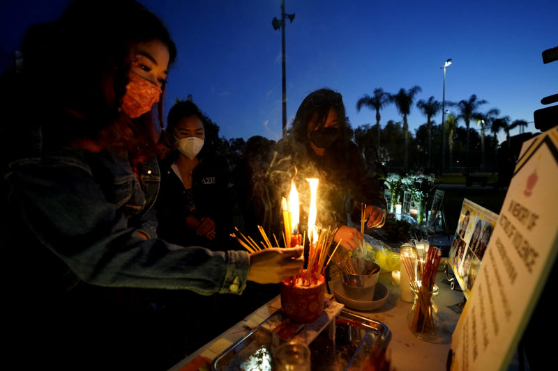 Women pay theirs respects at a memorial in honor of the victims of the shootings in Atlanta, where eight people were killed the week before, during a candle vigil in Monterrey Park, Calif., late Saturday, March 27, 2021. The shootings at three Georgia massage parlors and spas that left eight people dead, six of them women of Asian descent, come on the heels of a recent wave of attacks against Asian Americans since the coronavirus entered the United States. AP Photo/Damian Dovarganes