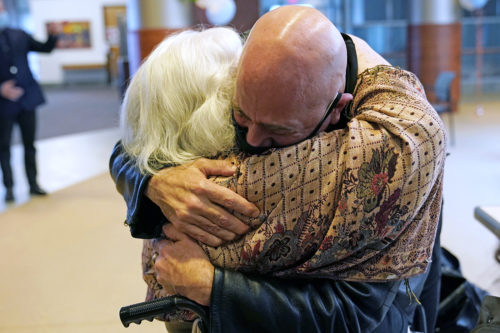 Adam Sternbach, right, embraces his 89 year-old mother Maryann Sternbach for the first time in over a year inside the Hebrew Home at Riverdale in New York. Because of the loosening of COVID-19 restrictions, it was the first time in over a year families of the nursing homes residents were allowed indoor, in-person visits.  AP Photo/Kathy Willens