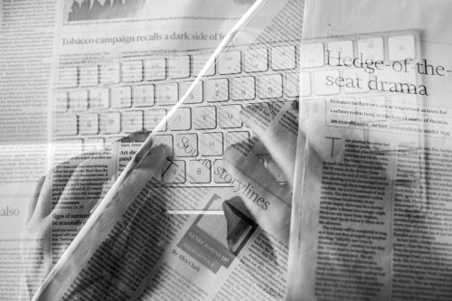 A montage of newspapers eclipsed by a computer keyboard as community journalism moves online