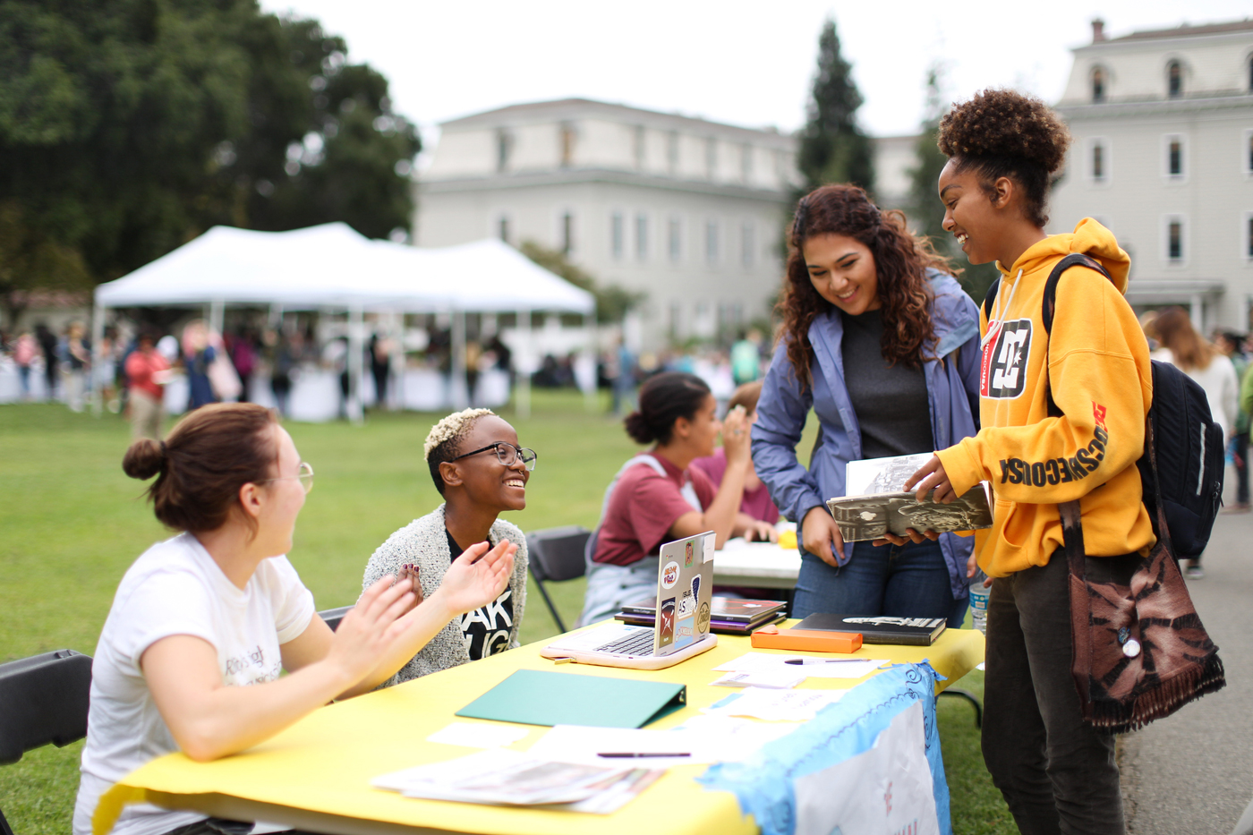 Mills College students learn about opportunities for community engagement through academic programs, student-run clubs, and local organizations at the 2017 fall Community Action Fair, held on Holmgren Meadow in the center of the Mills campus in Oakland, California.