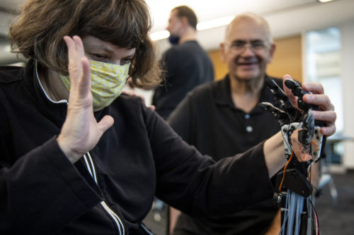 Jaimi Lard, who is blind and deaf, feels the TATUM robotic hand to try to determine what letter it is spelling during a validation study at the Northeastern University Interdisciplinary Science & Engineering Complex. Photo by Alyssa Stone/Northeastern University