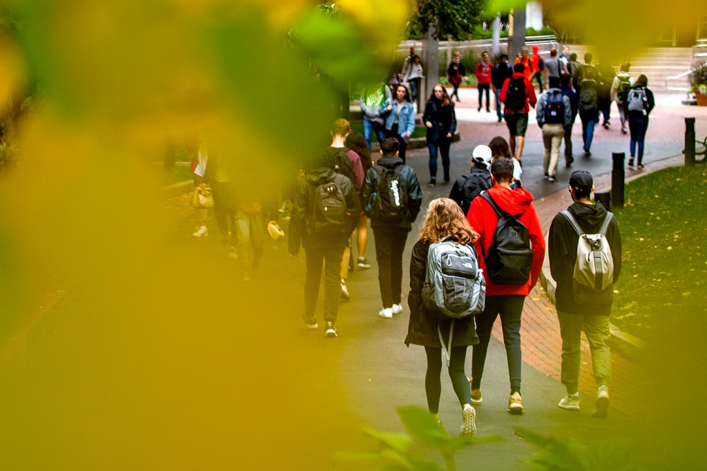 Members of the Northeastern community walk around the Boston campus in the fall. The university announced on Monday that faculty and staff based in the United States will need to submit verification of vaccination by Sept. 8, 2021.