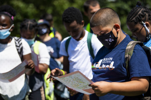 A camper with the Boston Explorers looks at a campus map during a tour of Northeastern University. Photo by Alyssa Stone/Northeastern University