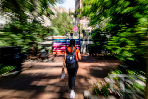 A student walks past Curry Student Center. Photo by Matthew Modoono/Northeastern University