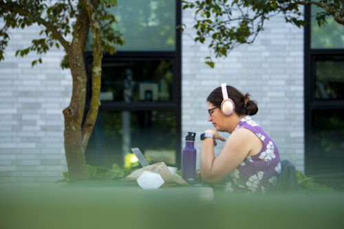 Director of the EDD Graduate School of Education, Sara Ewell does work outside in the Richardson Plaza before the heat wave hits later in the day. Photo by Alyssa Stone/Northeastern University