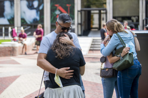 Northeastern parents embrace students on move-in day in Boston. Photo by Alyssa Stone/Northeastern University