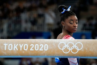 Simone Biles, of the United States, prepares to start her performance on the balance beam during the artistic gymnastics women's apparatus final at the 2020 Summer Olympics.