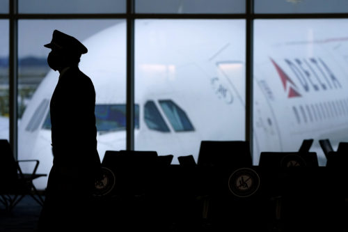 silhouette of a pilot in front of a delta airplane