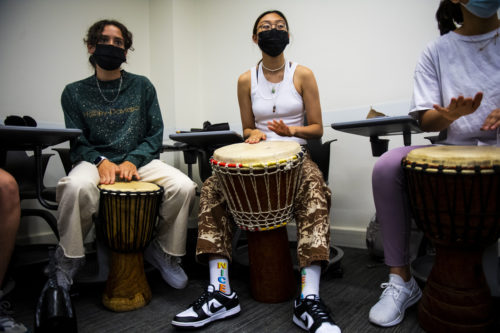 Northeastern honors students participate in a community drum circle celebrating the healing powers of music in Snell Library. Photo by Alyssa Stone/Northeastern University