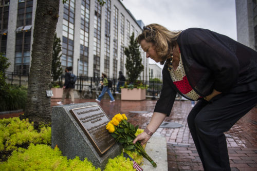 northeastern dean places yellow roses on candace lee williams memorial