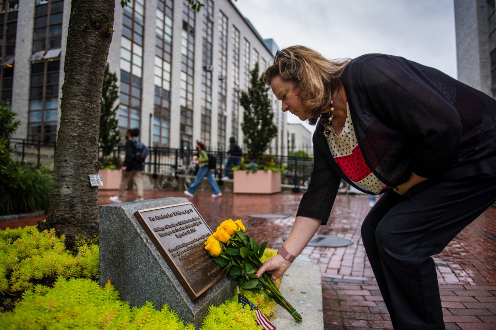 northeastern dean places yellow roses on candace lee williams memorial