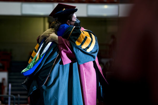 northeastern doctoral graduate hugging their advisor