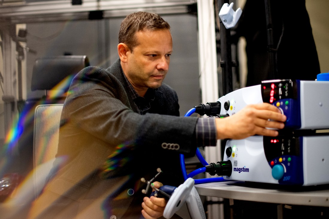 Gene Tunik using a machine in a lab.