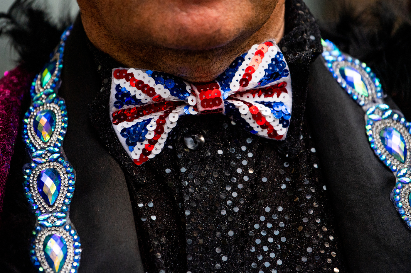elton john impersonator wearing a sequined union jack bow tie