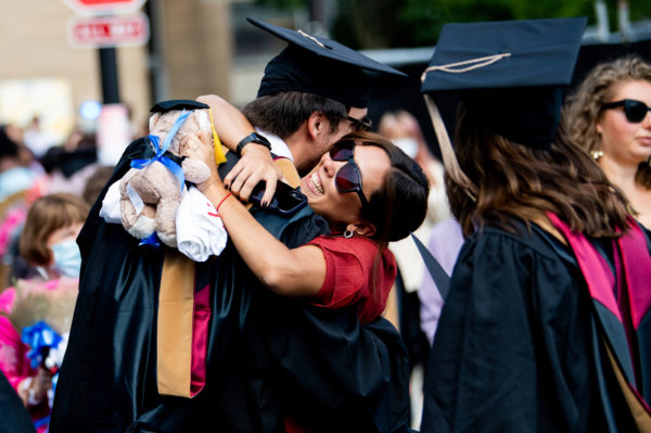northeastern graduate hugs a young woman