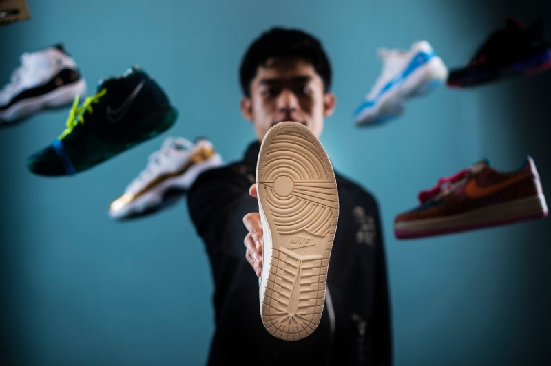 student holding a nike shoe sole facing forward