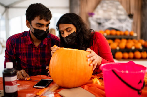 Prakash Kumar a masters student studying computer science, and Rupali Mepkari a masters student studying analytics, carve a pumpkin during the 21st Annual Northeastern Dining pumpkin carving contest held in the Willis Tent.  Photo by Matthew Modoono/Northeastern University