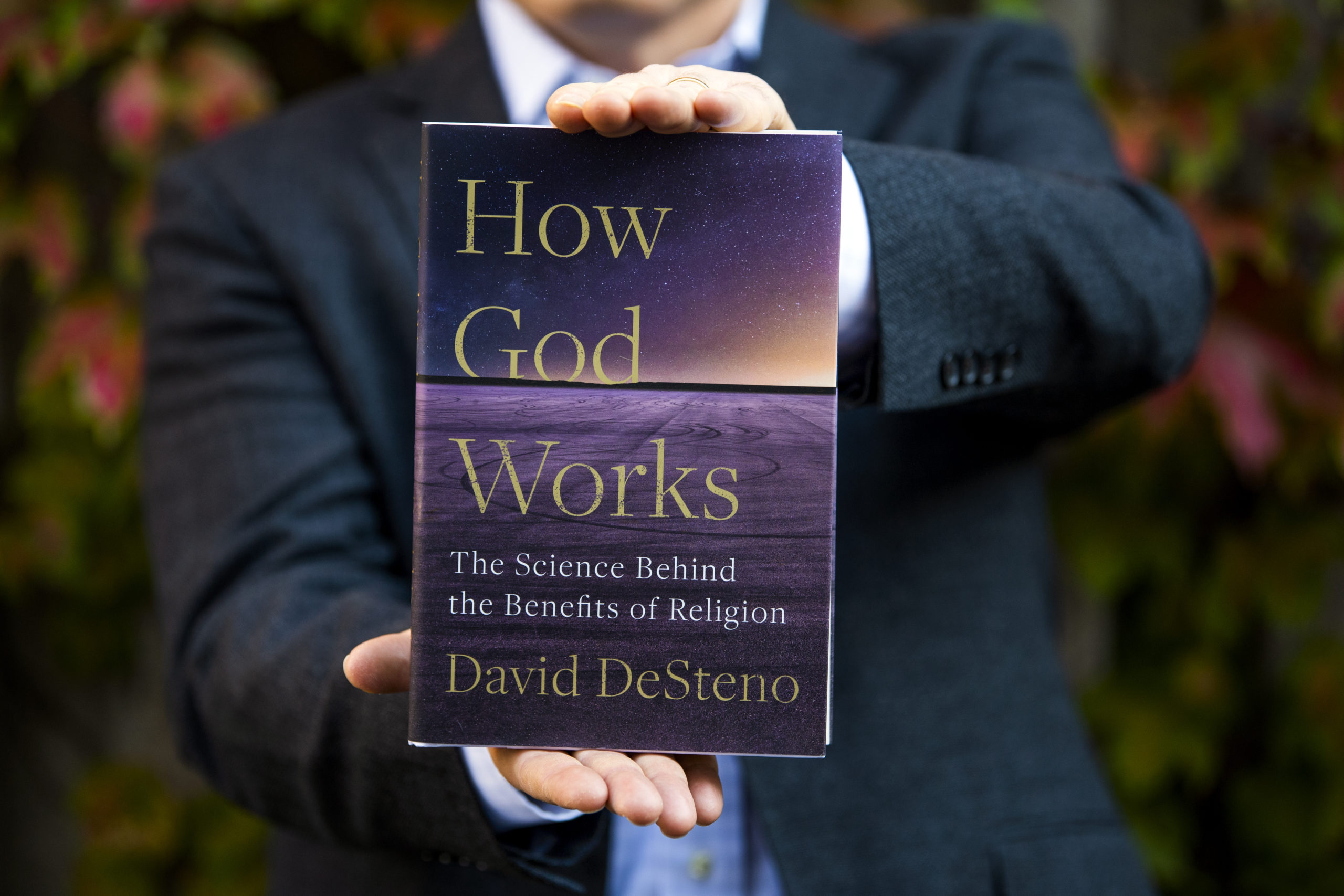 David DeSteno holds a copy of his new book, "How God Works."