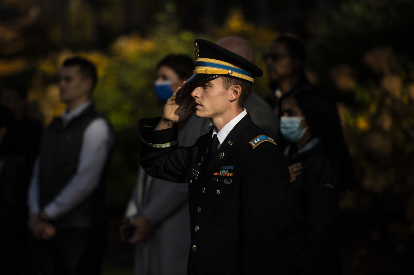 a uniformed man stands at salute