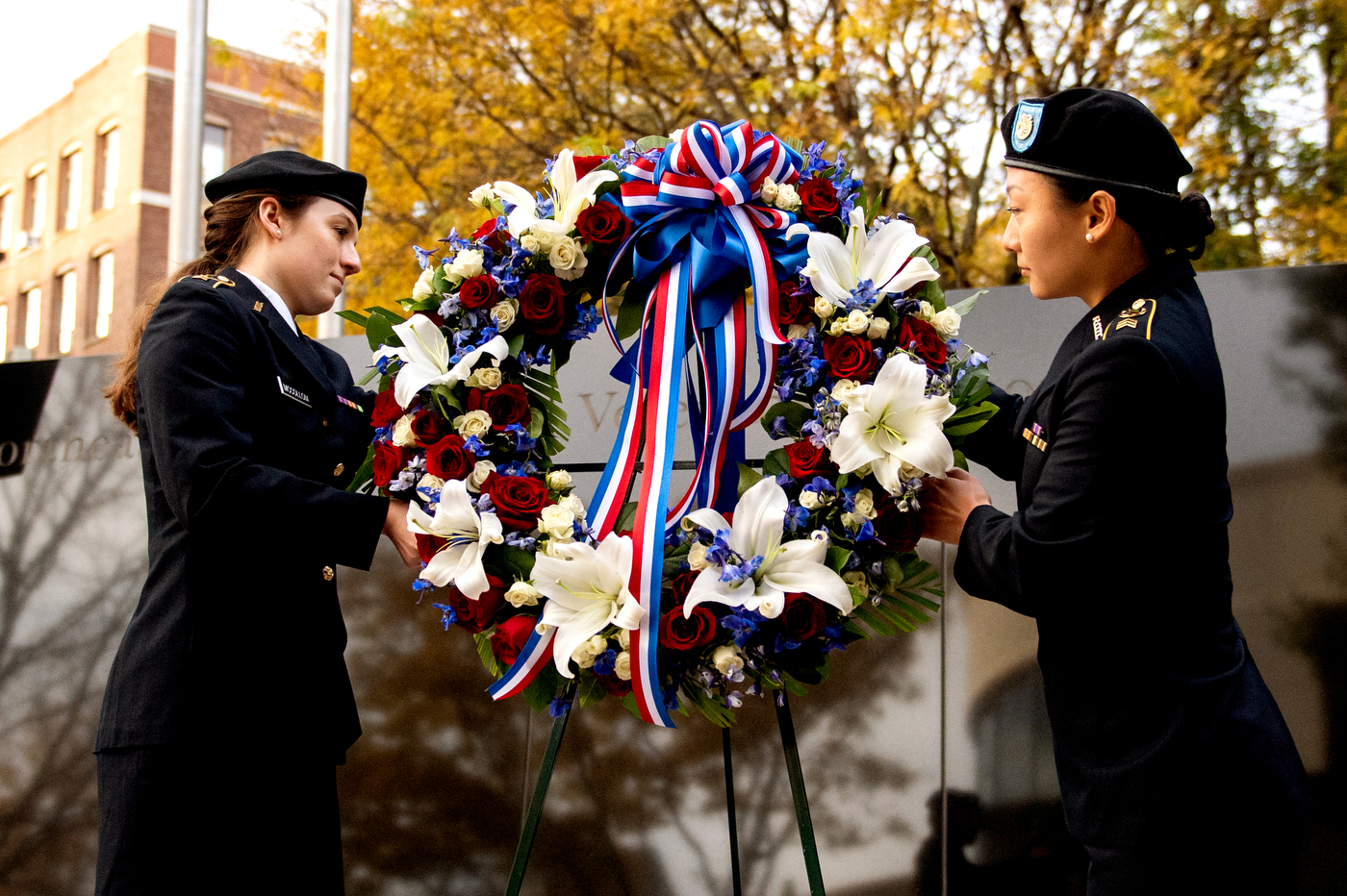 two rotc students placing a wreath on a stand