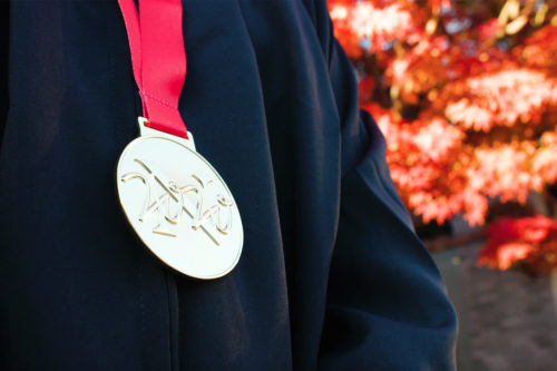 gold medal on red ribbon with 2020 engraved on it