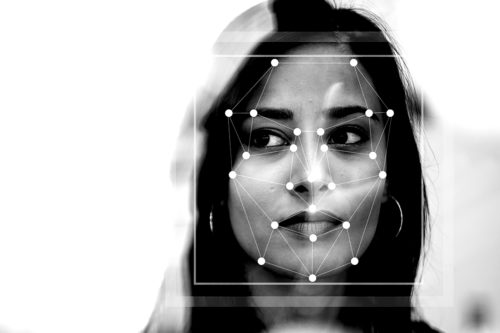 womans face with facial recognition pattern overlayed