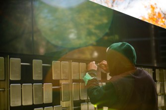 man polishes a silver plaque