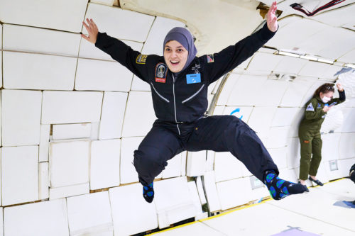 woman floats in zero gravity with her arms and legs outstretched