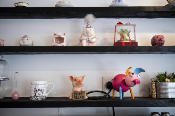 three shelves with pig decorations on them