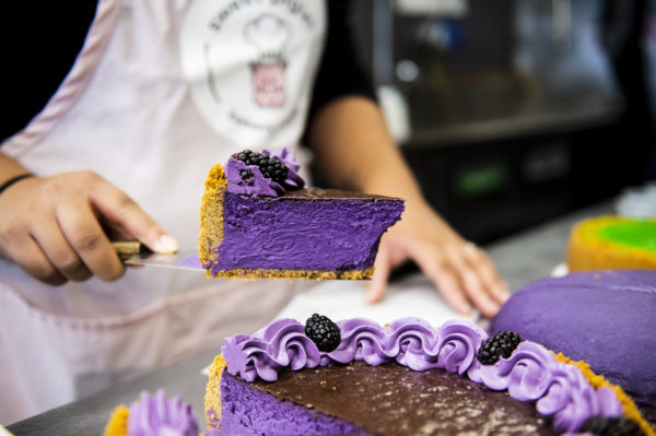 slice of purple cake with chocolate topping and graham cracker crust