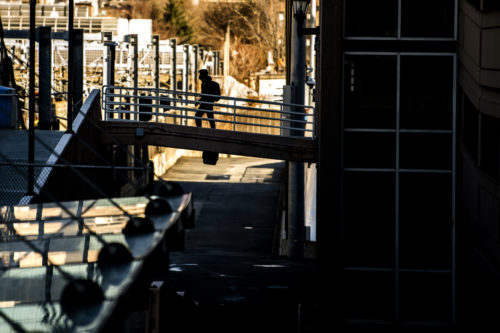 A student crosses over the bridge connecting Columbus Parking Garage to Northeastern's Boston campus. Photo by Matthew Modoono/Northeastern University