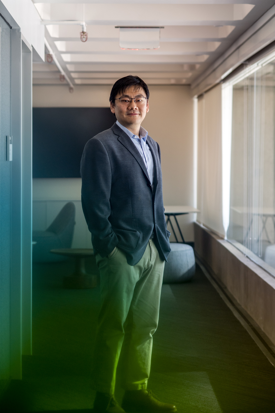 Northeastern assistant physics professor Max Bi poses for a portrait in his office. Bi recently earned the Sloan research fellowship.