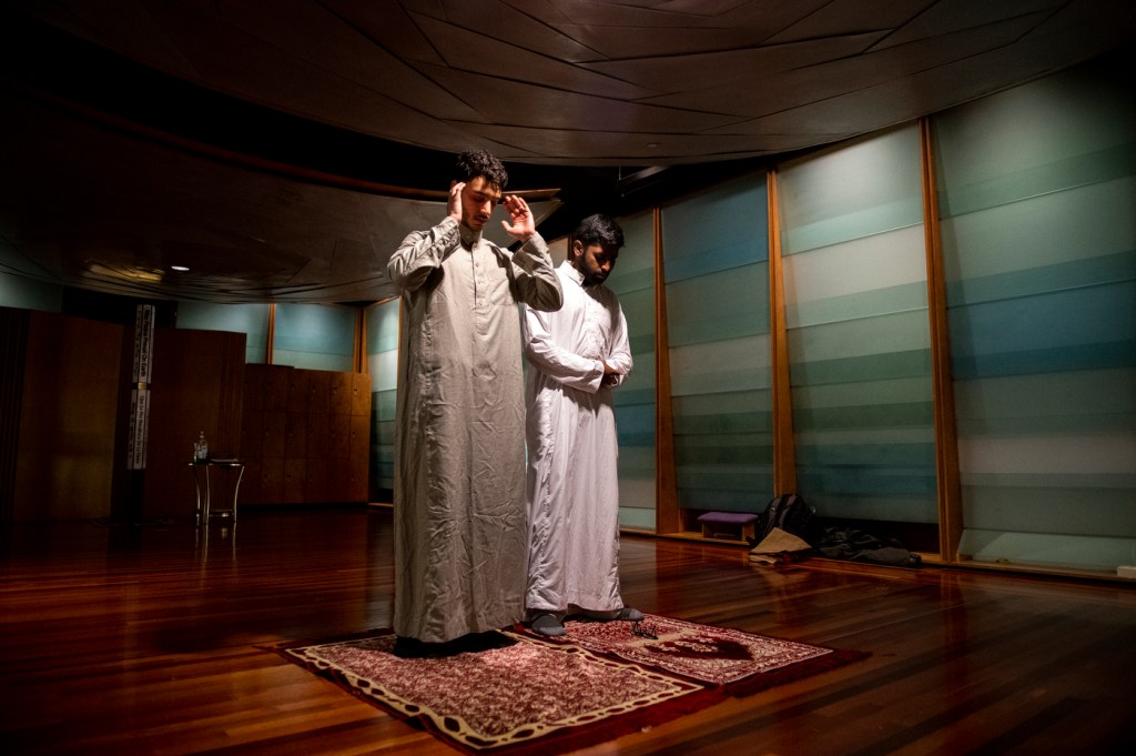 Northeastern students Omar Shoura and Shoyaib Shaik pray in the Sacred Space in Ell Hall.
