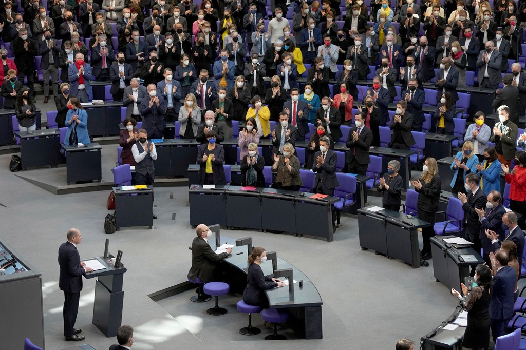 Lawmakers applaud during German Chancellor Olaf Scholz' speech on the Russian invasion of the Ukraine during a meeting of the German federal parliament, Bundestag, at the Reichstag building in Berlin, Germany, Feb. 27, 2022. Nowhere has the change been more pronounced than in Germany, the European Union's leading economic power but also a country that has been reluctant to invest heavily in military power, in large part because of its militaristic past which resulted in the horror of World War II.