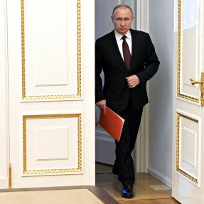 president vladimir putin walking through a doorway