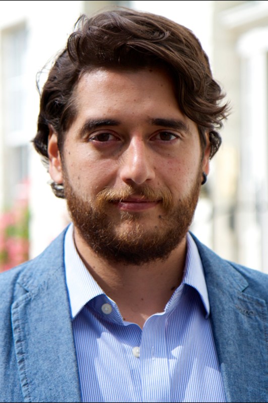 Headshot of Pablo Calderon Martinez  in a professional headshot wearing a blue blazer over a blue-striped dress shirt.