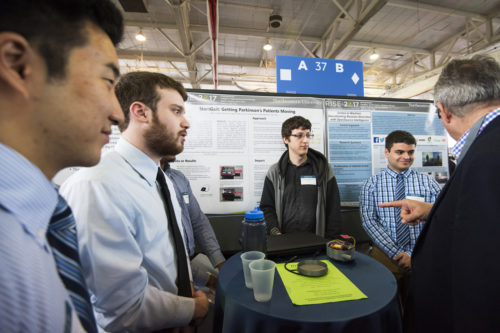 A student team led by Justin Schwartzseid, E’17, center, wants to do something to help people with Parkinson's disease deal with its effects. Photo by Adam Glanzman/Northeastern University