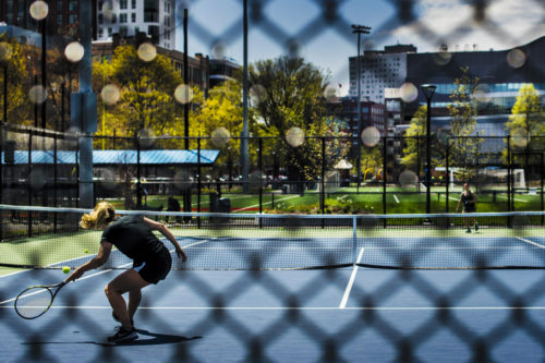 Students play tennis on the Carter Playground courts. Photo by Adam Glanzman/Northeastern University