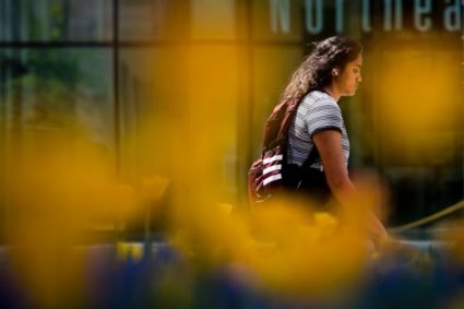 A member of the Northeastern community walks down Forsyth Ave on the Boston campus. Photo by Alyssa Stone/Northeastern University