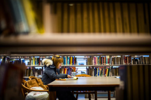 In this file photo, Qi You, who graduated in 2018, studies in Snell Library on March 6, 2018. Photo by Matthew Modoono/Northeastern University