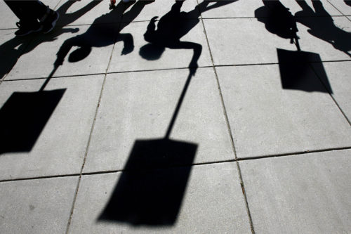 Students from Dunbar Senior High School in Washington are silhouetted as they protest the city's plan to close 23 schools in the fall due to declining enrollment, at a gathering outside the office of the D.C. Schools Chancellor in Washington, on Friday May 23, 2008. Dunbar was not slated for closing. AP Photo/Jacquelyn Martin
