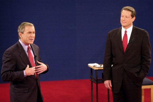 In this Oct. 17, 2000 file photo, Republican presidential candidate, Texas Gov. George W. Bush, left, speaks as Democratic presidential candidate Vice President Al Gore watches during their third and final debate at Washington University in St. Louis. AP Photo by Ed Reinke