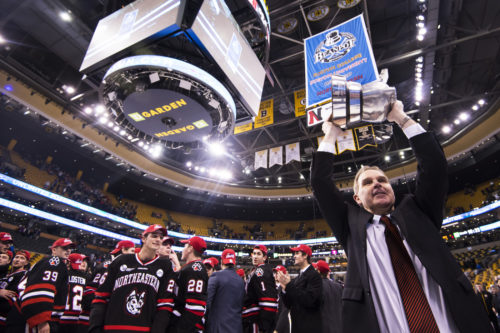 Northeastern men's hockey coach Jim Madigan hoists the Beanpot. Photo by Adam Glanzman/Northeastern University