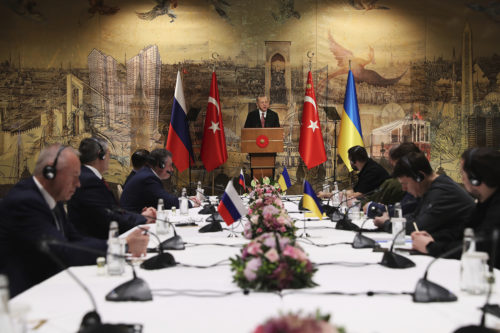 In this photo provided by Turkish Presidency, Turkish President Recep Tayyip Erdogan, center, gives a speech to welcome the Russian, left, and Ukrainian delegations ahead of their talks, in Istanbul, Turkey, Tuesday, March 29, 2022.