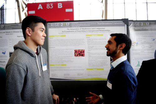 Dipak Aggarwal, S’20, right, and Ming Nok Lo, S’19, left, are investigating the similarities and differences between certain scientific and philosophical ideologies as they relate to mindfulness and compassion. Photo by Matthew Modoono/Northeastern University